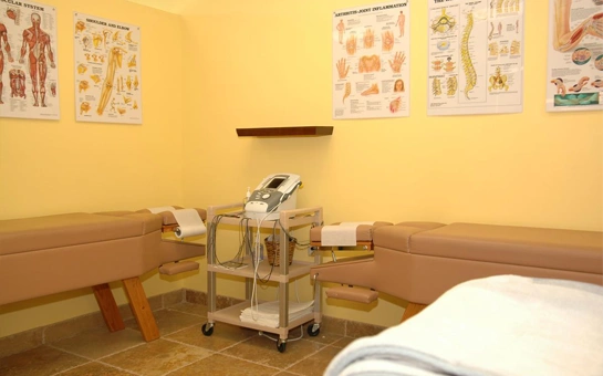 Chiropractic therapy room with exam tables and medical device